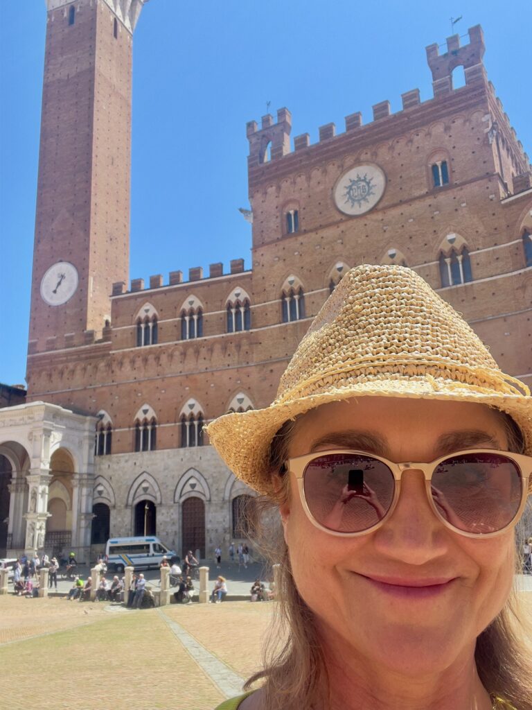 Leanne in front of a historical building in Italy.